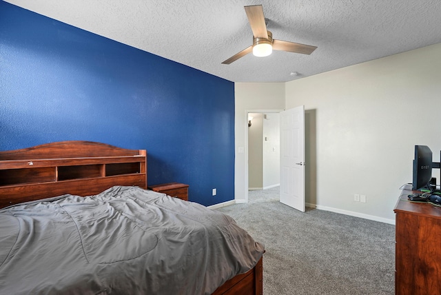 bedroom featuring baseboards, a textured ceiling, carpet, and ceiling fan