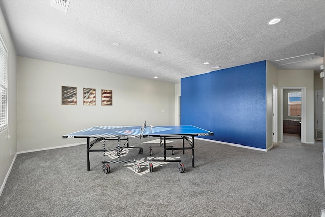 game room with baseboards, carpet, a textured ceiling, and visible vents