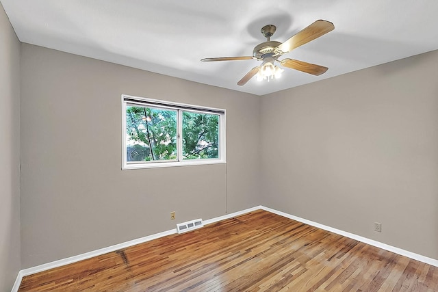unfurnished room with baseboards, visible vents, ceiling fan, and light wood-style floors