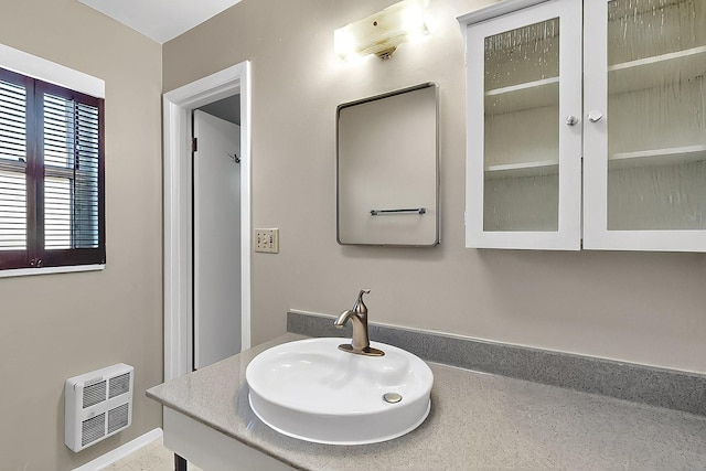 bathroom with vanity and heating unit
