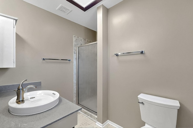 bathroom with visible vents, a sink, toilet, and a shower stall