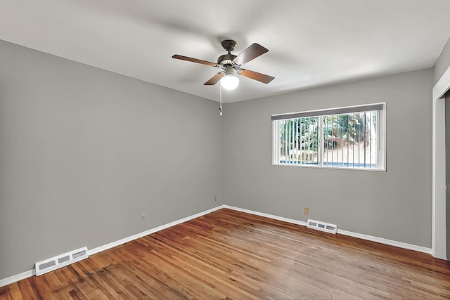 empty room with ceiling fan, visible vents, and baseboards