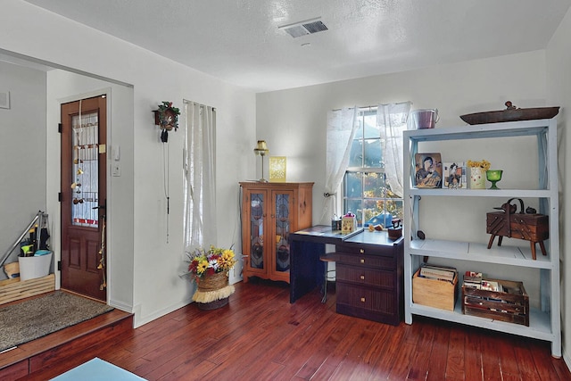 office space with visible vents and wood finished floors