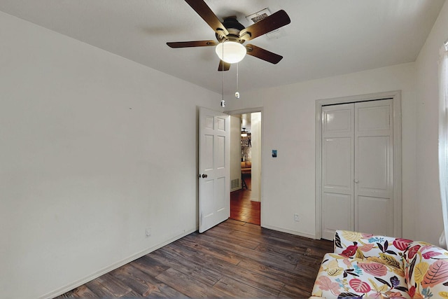 bedroom featuring visible vents, a closet, baseboards, ceiling fan, and dark wood-type flooring