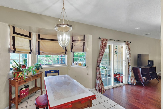 dining space featuring an inviting chandelier, tile patterned flooring, and visible vents