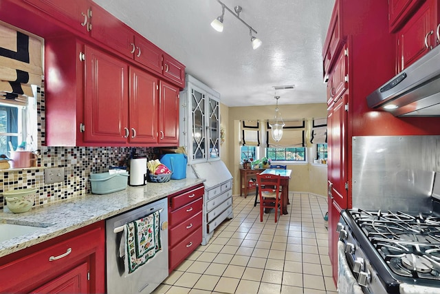 kitchen with exhaust hood, appliances with stainless steel finishes, decorative backsplash, light tile patterned floors, and visible vents