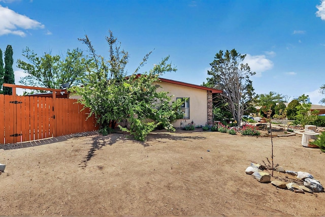 view of yard featuring fence and a gate