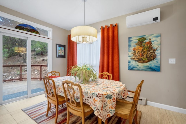 dining room with baseboards, light wood-style floors, baseboard heating, and a wall mounted air conditioner