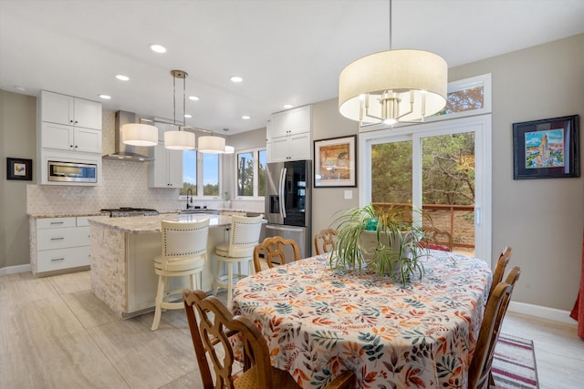 dining area with baseboards, recessed lighting, light wood-style flooring, and a wealth of natural light