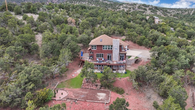 birds eye view of property featuring a view of trees
