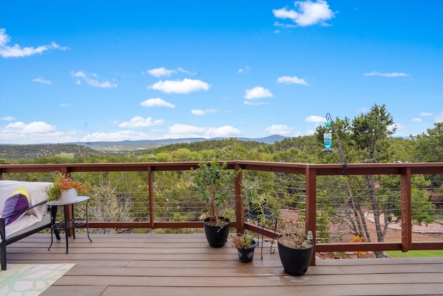wooden deck with a mountain view
