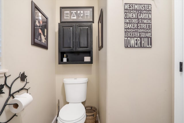 bathroom featuring baseboards and toilet