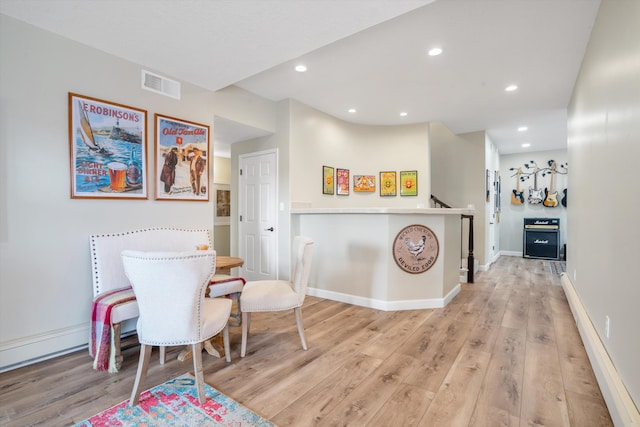 dining area featuring recessed lighting, baseboard heating, light wood finished floors, and visible vents