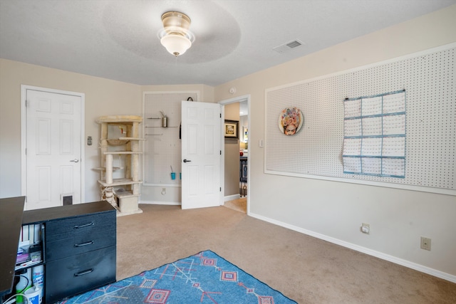 unfurnished bedroom featuring carpet floors, baseboards, and visible vents