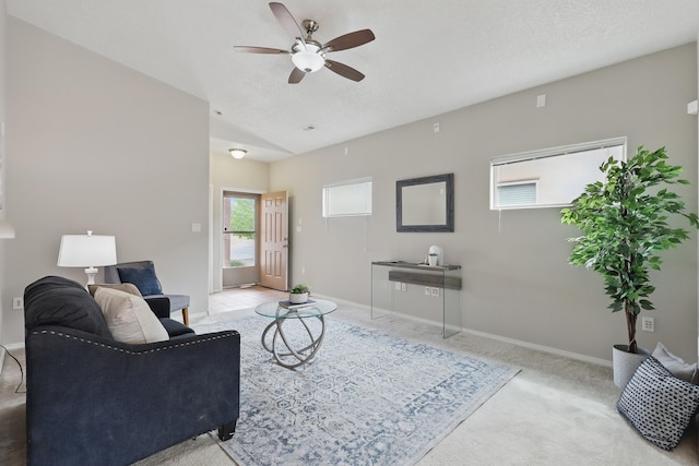 carpeted living room with baseboards, a ceiling fan, and lofted ceiling