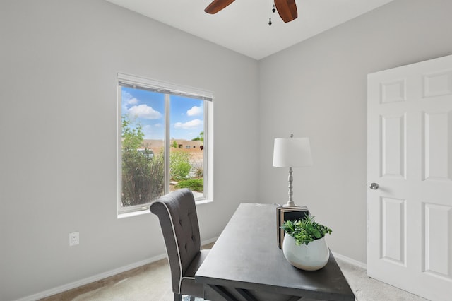 office featuring a ceiling fan, light carpet, plenty of natural light, and baseboards