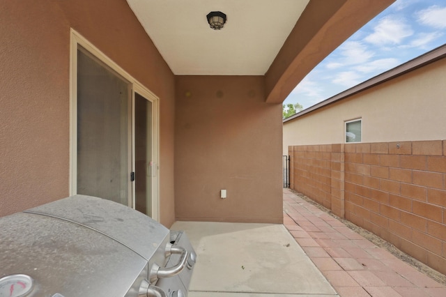view of patio / terrace featuring a grill and fence