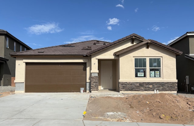 3230 Matador St SE, Rio Rancho, NM 87144 - ranch-style home featuring stucco siding, a garage, driveway, and stone siding