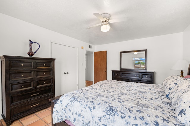 bedroom featuring a closet, ceiling fan, and light tile patterned flooring