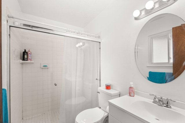 full bathroom featuring a stall shower, vanity, and toilet