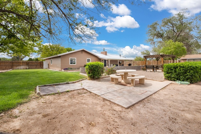 rear view of property featuring a pergola, a patio area, and a chimney