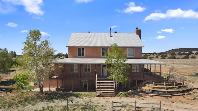 19 Sage Ct, Edgewood, NM 87015 - back of house featuring stairway, metal roof, a chimney, fence, and a porch