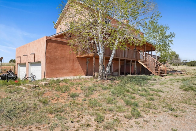 19 Sage Ct, Edgewood, NM 87015 - view of property exterior featuring a garage, stairway, and a deck