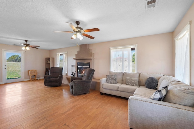 19 Sage Ct, Edgewood, NM 87015 - living area with a ceiling fan, light wood finished floors, plenty of natural light, and a textured ceiling