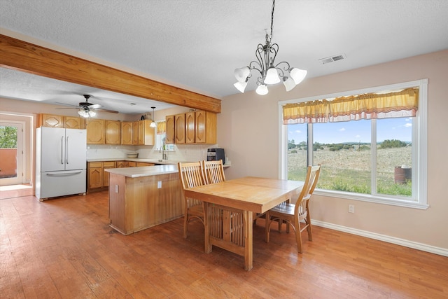 19 Sage Ct, Edgewood, NM 87015 - dining area with light wood-style flooring, baseboards, a chandelier, a textured ceiling, and ceiling fan