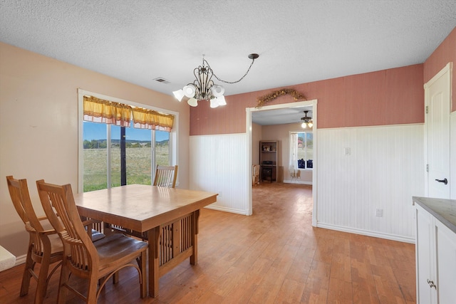 19 Sage Ct, Edgewood, NM 87015 - dining area featuring a chandelier, light wood-style floors, baseboards, a textured ceiling, and a ceiling fan