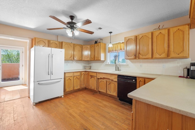 19 Sage Ct, Edgewood, NM 87015 - kitchen with freestanding refrigerator, black dishwasher, a sink, light wood-style flooring, and light countertops