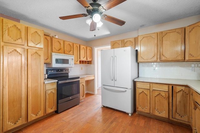 19 Sage Ct, Edgewood, NM 87015 - kitchen featuring white appliances, light countertops, a ceiling fan, light wood-style flooring, and decorative backsplash