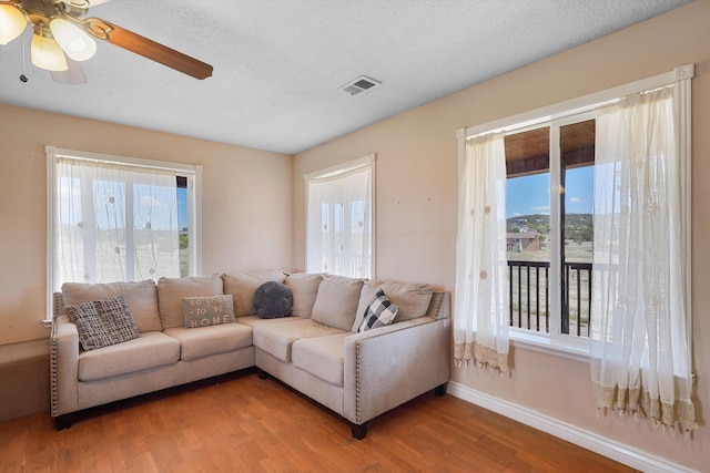 19 Sage Ct, Edgewood, NM 87015 - living area with baseboards, wood finished floors, a ceiling fan, and a textured ceiling