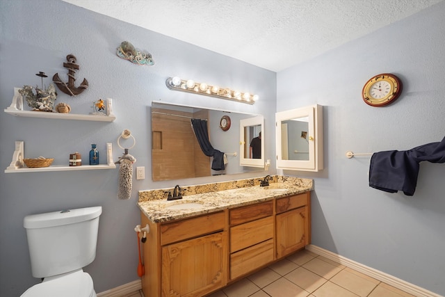 19 Sage Ct, Edgewood, NM 87015 - bathroom featuring toilet, tile patterned flooring, a textured ceiling, double vanity, and baseboards