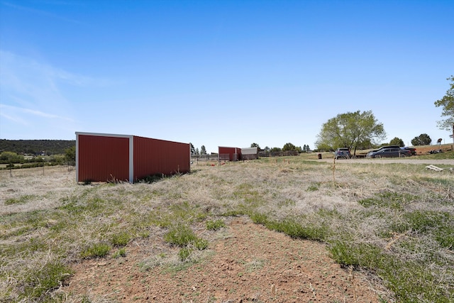 19 Sage Ct, Edgewood, NM 87015 - view of yard featuring a rural view, a pole building, and an outdoor structure