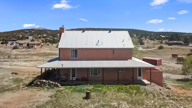 19 Sage Ct, Edgewood, NM 87015 - rear view of house with metal roof, a mountain view, and stucco siding