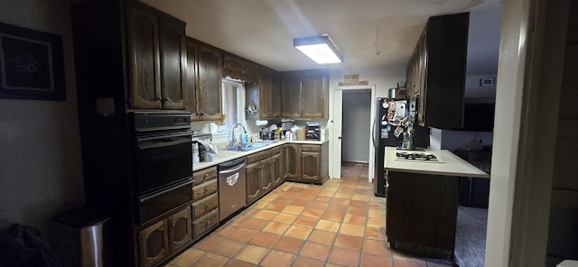 kitchen featuring a sink, black oven, a warming drawer, light countertops, and stainless steel dishwasher