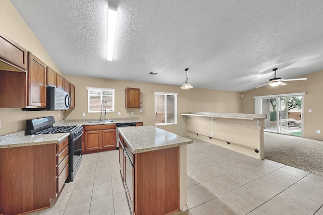 7229 Skagway Dr NE, Rio Rancho, NM 87144 - kitchen featuring stainless steel appliances, a sink, light countertops, a textured ceiling, and brown cabinets