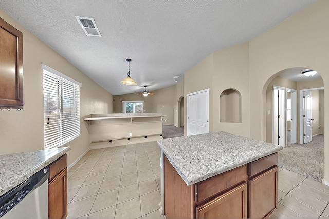 kitchen with dishwasher, arched walkways, light tile patterned floors, lofted ceiling, and a ceiling fan