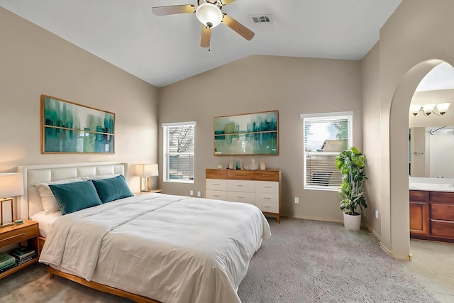 7229 Skagway Dr NE, Rio Rancho, NM 87144 - bedroom with arched walkways, lofted ceiling, ensuite bath, a ceiling fan, and baseboards