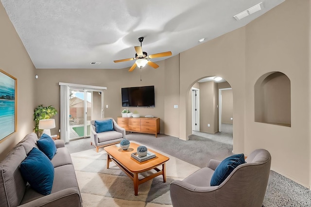 7229 Skagway Dr NE, Rio Rancho, NM 87144 - living area with light carpet, lofted ceiling, a ceiling fan, arched walkways, and baseboards