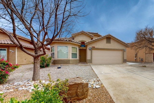 mediterranean / spanish house with stucco siding, an attached garage, driveway, and a tile roof