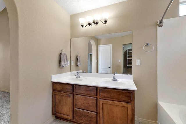 7229 Skagway Dr NE, Rio Rancho, NM 87144 - bathroom with baseboards, double vanity, and a bathtub