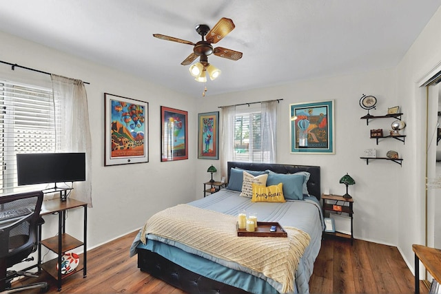 bedroom featuring ceiling fan, wood-type flooring, and baseboards