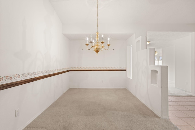 2105 Gila River Rd NE, Rio Rancho, NM 87144 - empty room featuring a chandelier, carpet, and baseboards