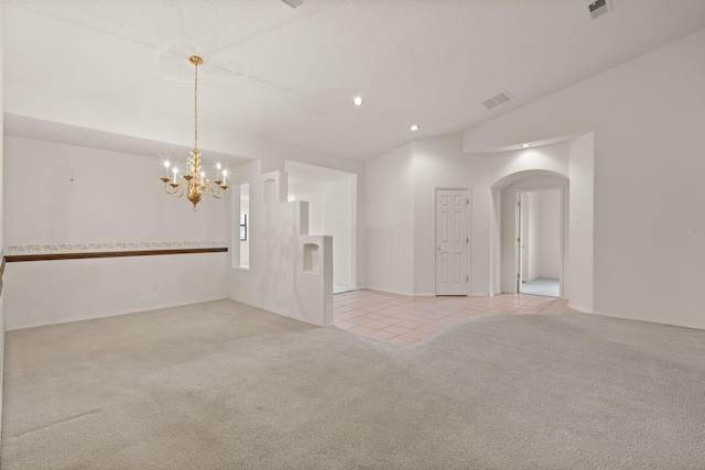 2105 Gila River Rd NE, Rio Rancho, NM 87144 - empty room with light carpet, a chandelier, arched walkways, light tile patterned floors, and recessed lighting
