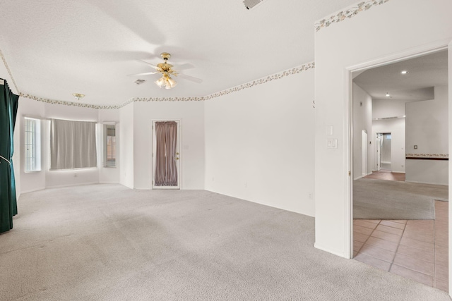 2105 Gila River Rd NE, Rio Rancho, NM 87144 - tiled spare room featuring carpet floors, ceiling fan, and baseboards