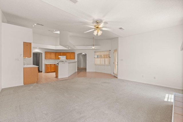 2105 Gila River Rd NE, Rio Rancho, NM 87144 - unfurnished living room featuring arched walkways, a ceiling fan, light carpet, and baseboards