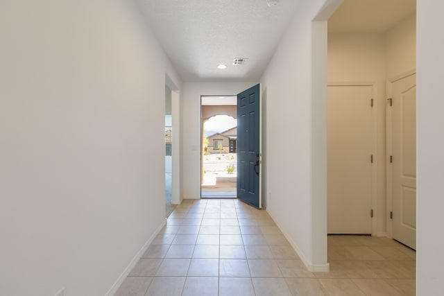 6791 Sydney Dr NE, Rio Rancho, NM 87144 - doorway with light tile patterned floors, baseboards, and a textured ceiling