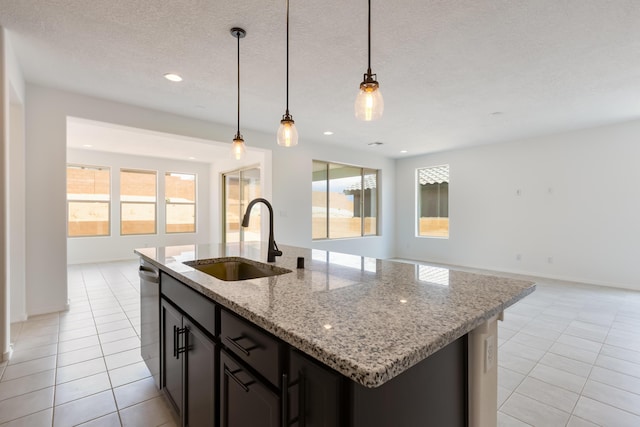 6791 Sydney Dr NE, Rio Rancho, NM 87144 - kitchen featuring a sink, light tile patterned floors, open floor plan, dishwasher, and a textured ceiling